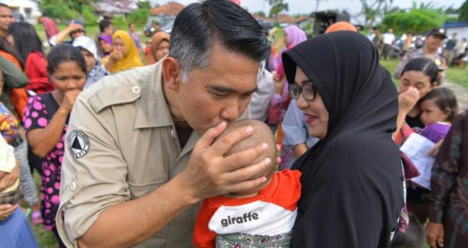 Walikota Jambi, Sy Fasha mencium anak salah satu warga Kota Jambi.