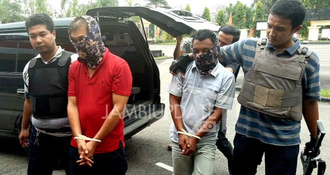 Tersangka MS dan AK, saat digiring ke Mapolres Tebo dengan pengawalan ketat, Senin (14/8).