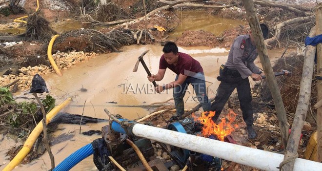 Pihak kepolisian saatmelakukan penindakan terhadap aktivitas Penambangan Emas Tanpa Izin (PETI).