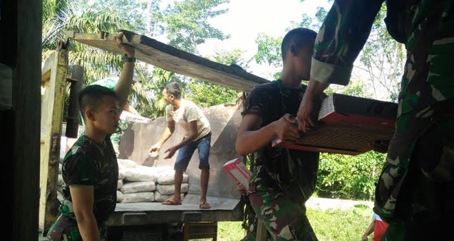 Babinsa dan Warga Bahu-membahu Turunkan Material Pembangunan Musholla.