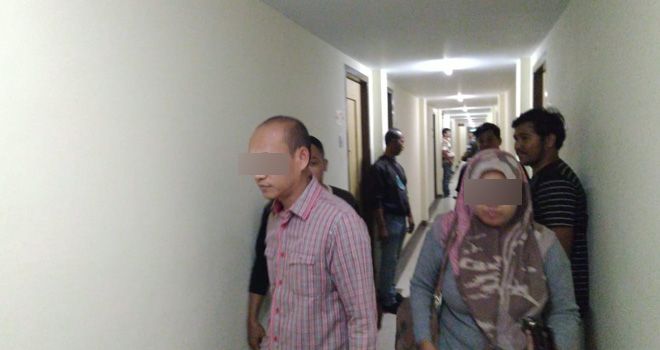 Petugas menggiring seorang tamu hotel yang diduga mesum tanpa identitas.

