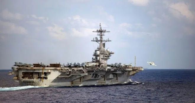 Kapal induk USS Theodore Roosevelt berada di dermaga di Guam setelah wabah Covid-19 menginfeksi sedikitnya 114 awak.