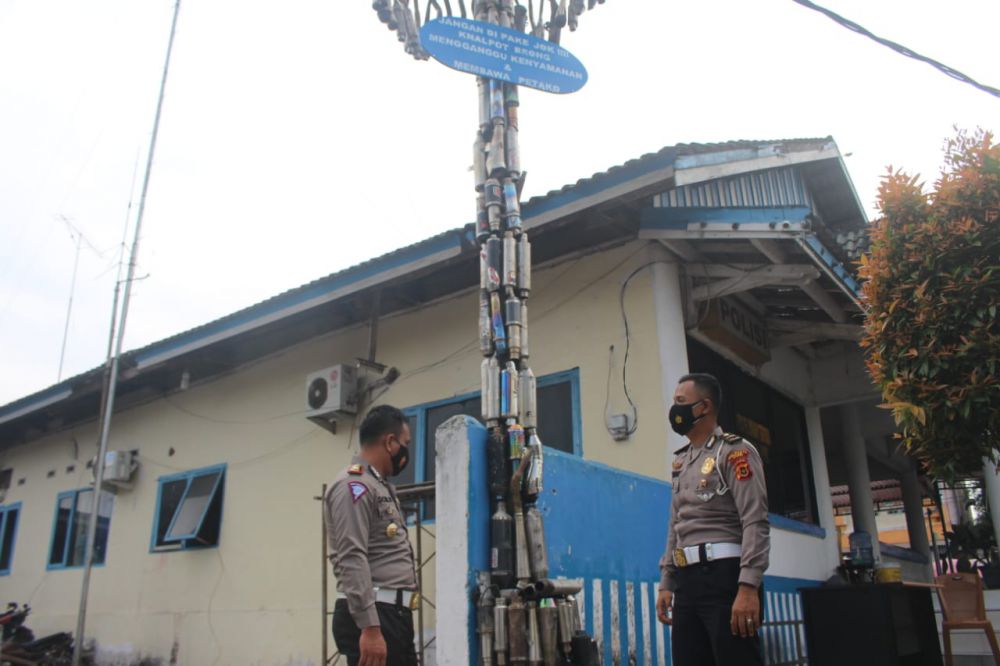 Polresta Jambi menyusun knalapot brong berbentuk tiang panjat pinang untuk menyampaikan pesan akumulatif terhadap warga Kota Jambi, Selasa (22/6).